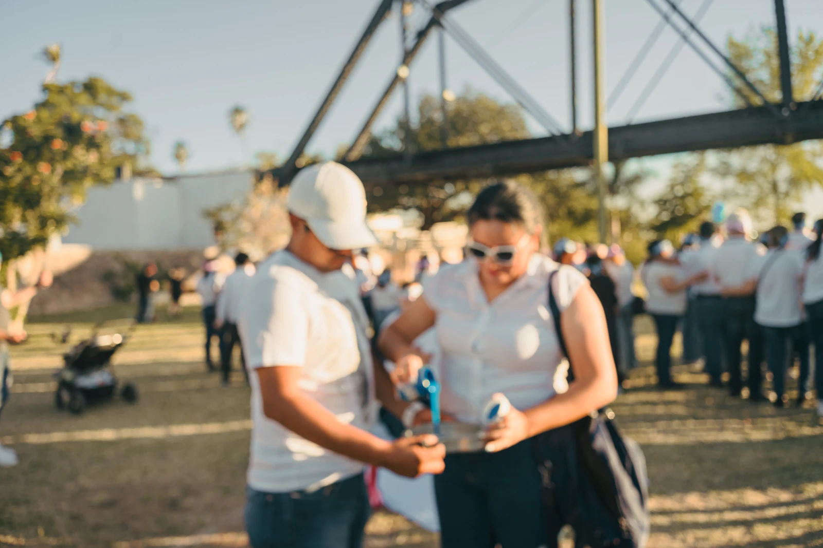 Two people meeting and talking at an outdoor gathering