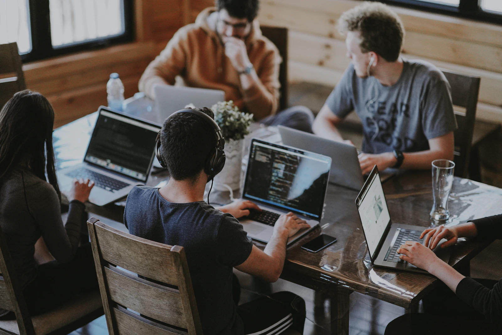 A small group sharing ideas around laptops in a workspace